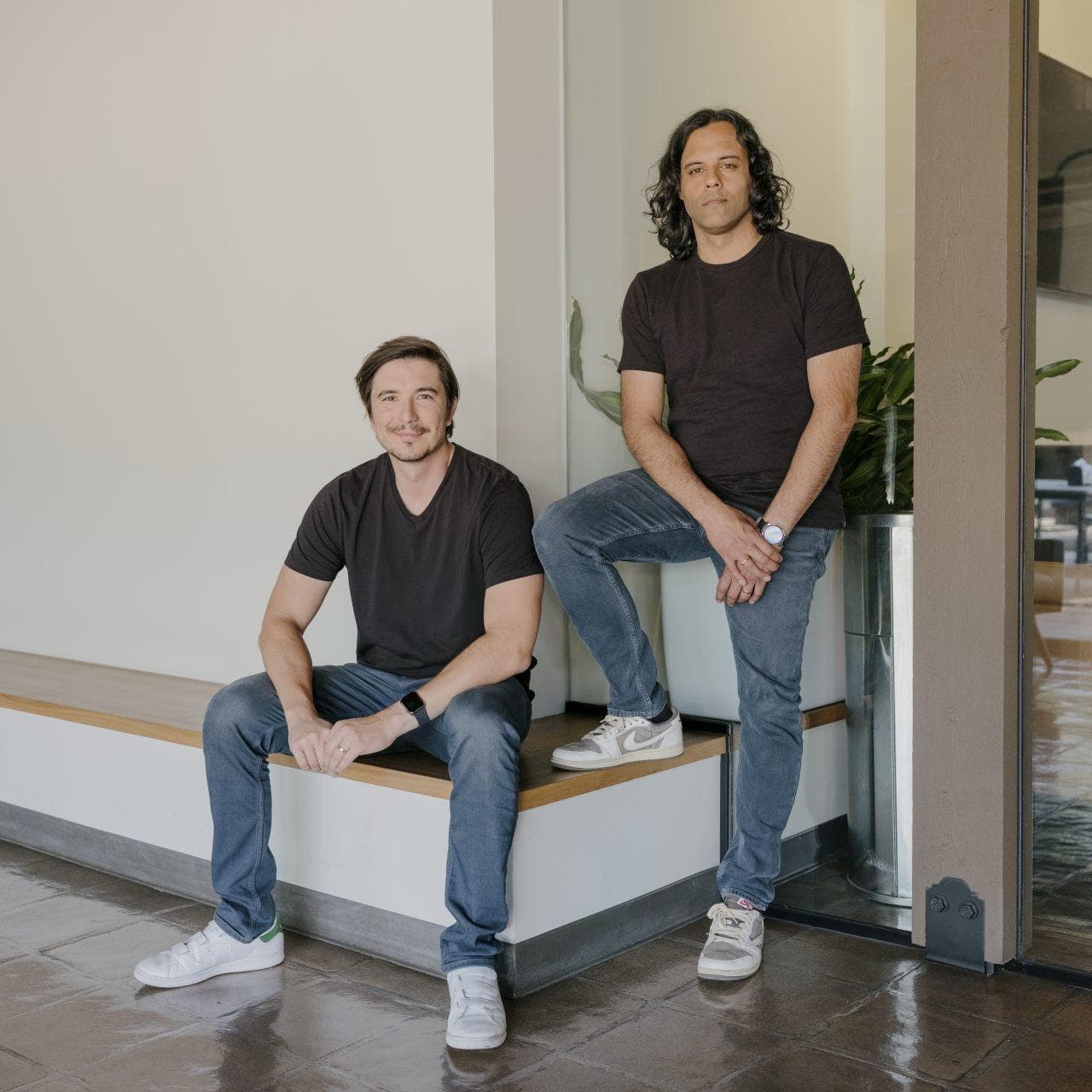 Robinhood co-founders Vlad Tenev, left, seated on a bench, and Baiju Bhatt standing beside him.